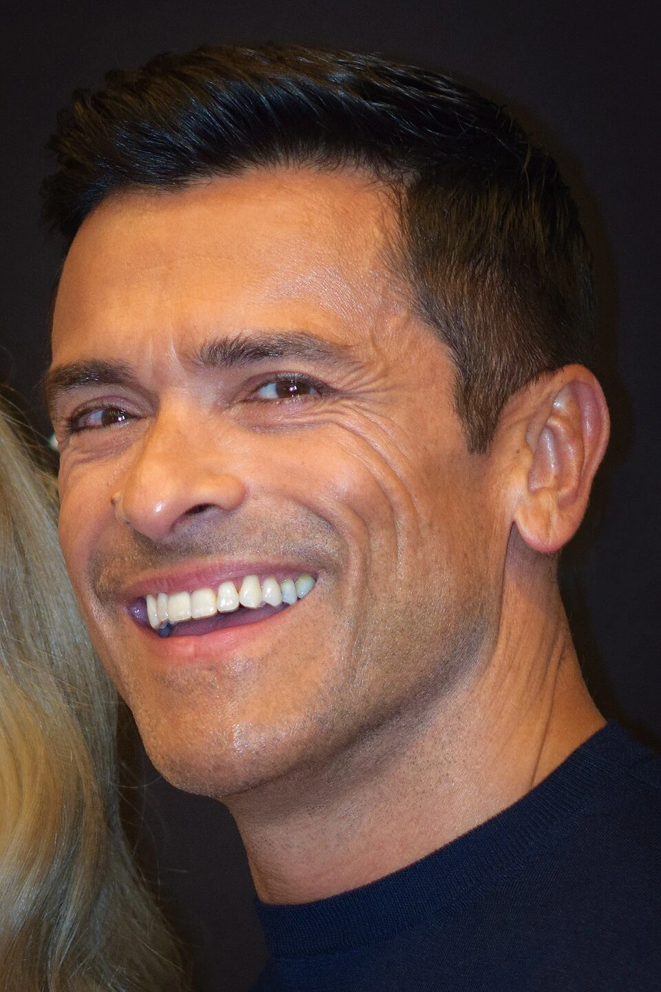 Mark Consuelos smiling in a close-up portrait photo