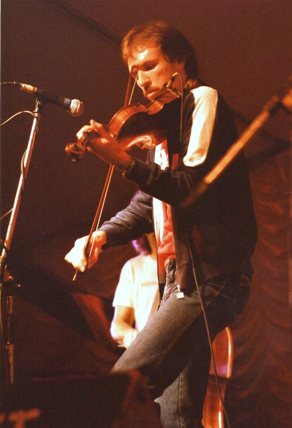 Mark O’Connor performing onstage with a fiddle in 1985.